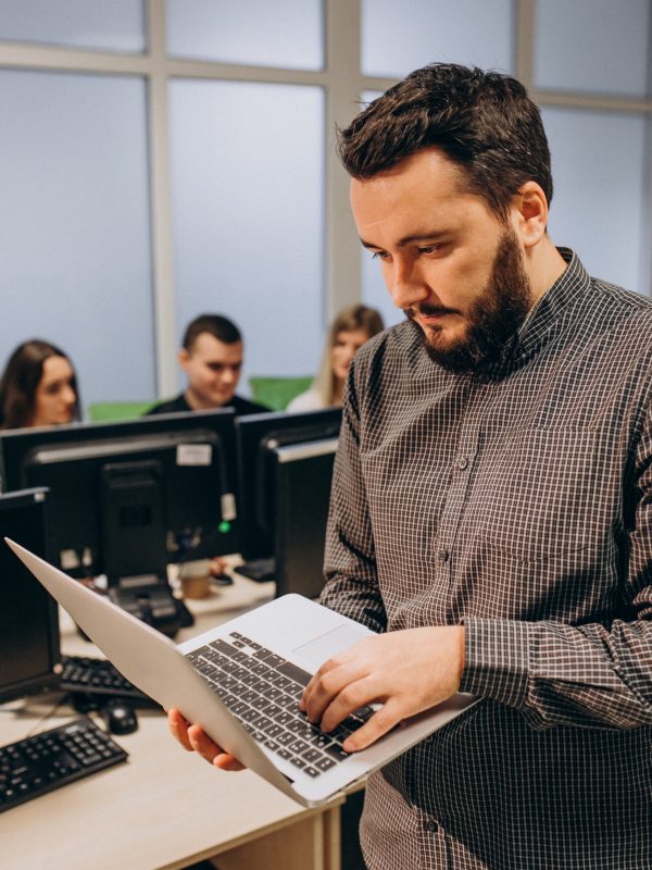 Workers at an IT company working on a computer